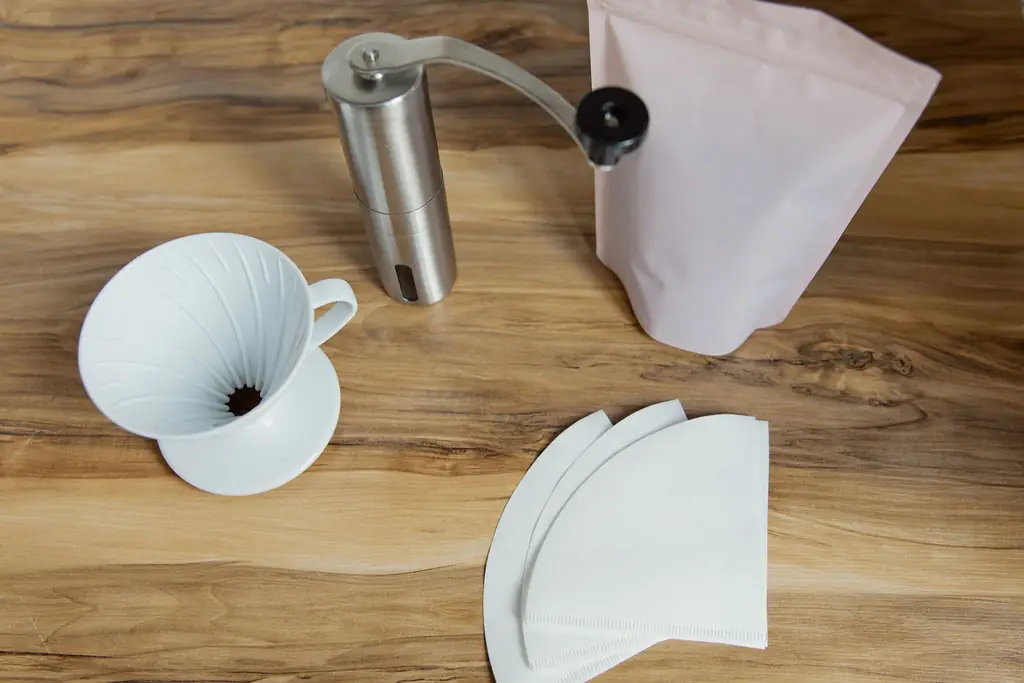 Grinder, dripper and filters on a wooden table
