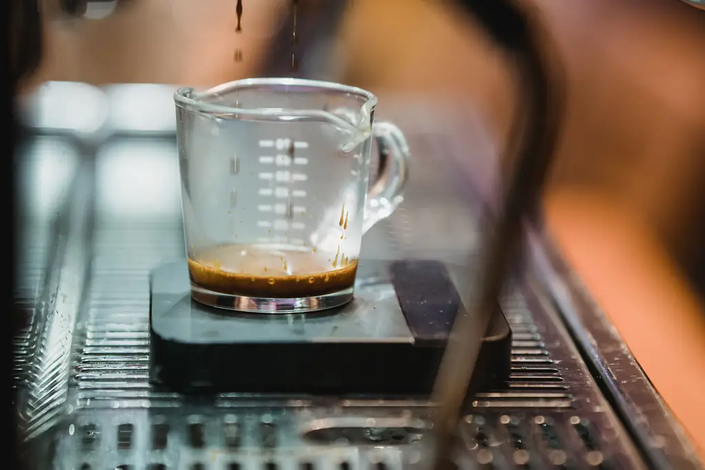 Espresso pouring from a machine into a glass